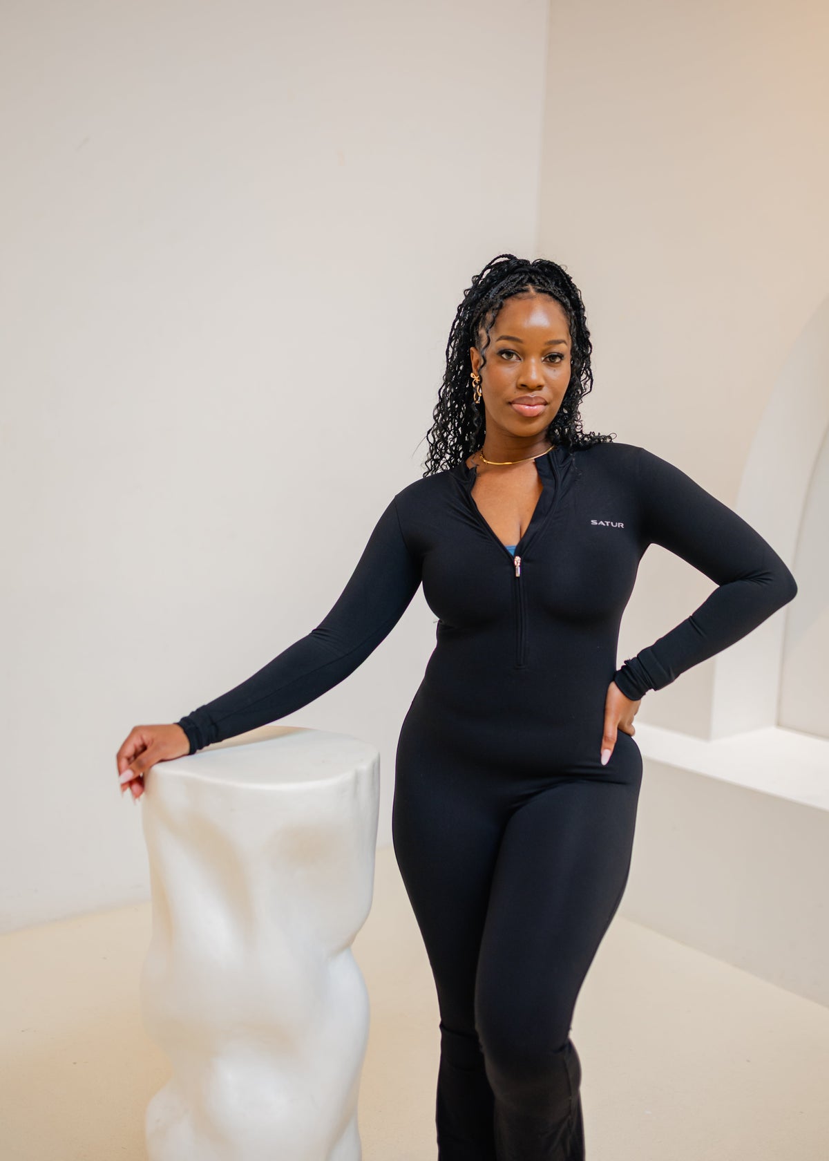Woman wearing the SaturSculpt Midnight Black Flare Jumpsuit